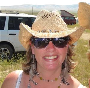 Headshot of Mrs. Roos wearing a straw hat and sunglasses